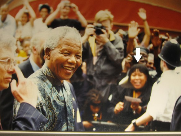 Diane Abbott (arrow in head), having walked 17 miles to purely coincidentally bump into Madiba,  tries to accidentally get into the same frame as the Great Statesman. Outside Tooting Village Hall, 1994